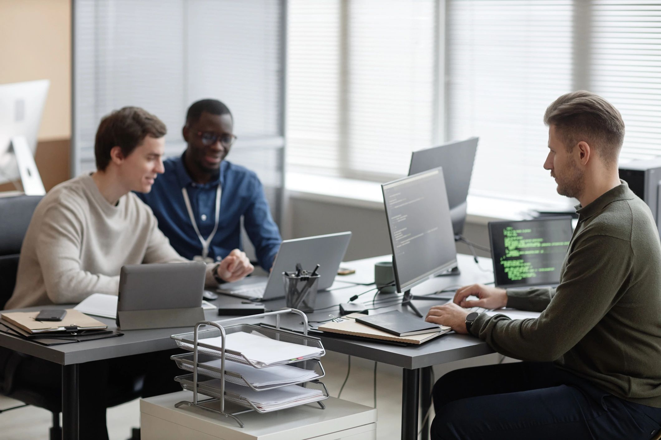 FPS mod creators collaborating at computers in a studio office